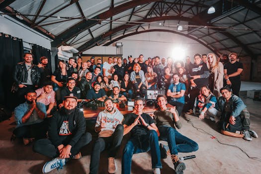 A happy and diverse group posing together in a São Paulo warehouse setting.